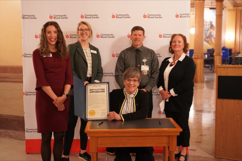 Kansas Governor Laura Kelly presents the Community Blood Center with a proclamation to raise awareness about the urgent need for blood donations, particularly during the challenging winter months.